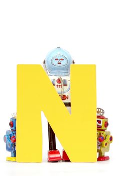 capital letter N  held by vintage robot toys 