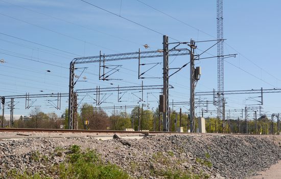 Numerous overhead lines above train tracks in Helsinki, Finland.