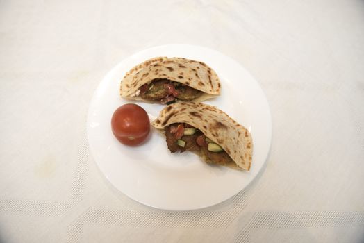 popular Israeli dish - falafel in a plate on a white tablecloth.