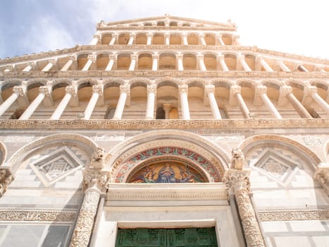 Front view of ornamental Romanesque portal of Pisa Cathedral - Roman Catholic cathedral dedicated to the Assumption of the Virgin Mary, Piazza dei Miracoli, Pisa, Tuscany, Italy. UNESCO World Heritage Site.