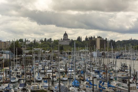 Marina with boats moored in Olympia Washington State by Capitol building on a cloudy day 