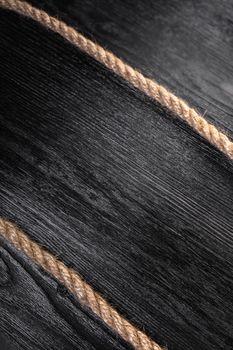 old rope closeup on black wooden background