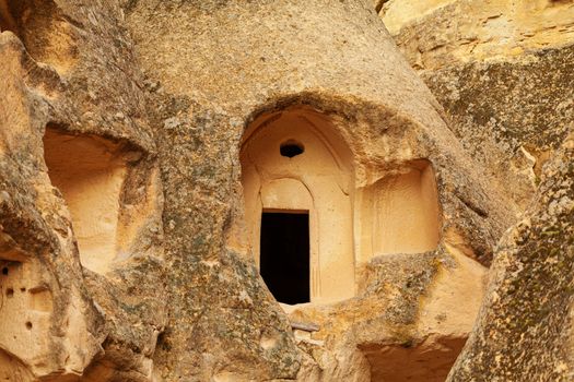 Cylindrical stone cliffs and cave houses near Goreme, Turkey