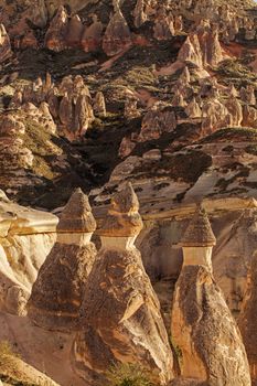 Cylindrical stone cliffs and cave houses near Goreme, Turkey