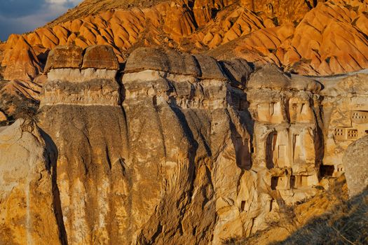 Cylindrical stone cliffs and cave houses near Goreme, Turkey