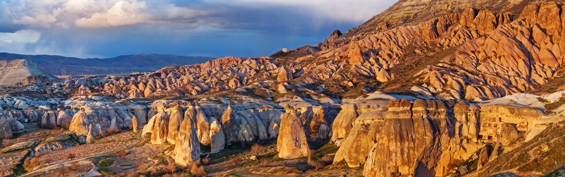 Cylindrical stone cliffs and cave houses near Goreme, Turkey