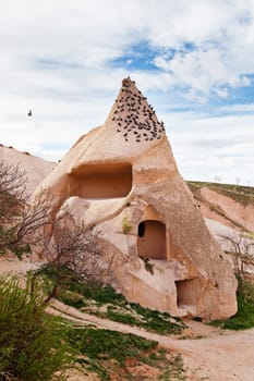 Stone cliffs and cave houses in Uchisar near Goreme, Turkey