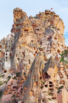 Stone cliffs and cave houses in Uchisar near Goreme, Turkey