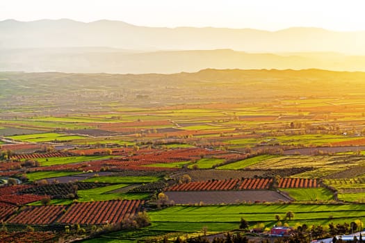 Aerial view of beutiful sunset over green and red agricultiral fields near Pamukkale in Turkey