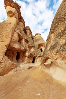Cylindrical stone cliffs and cave houses in Pasabag near Goreme, Turkey