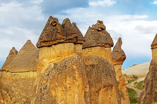 Cylindrical stone cliffs and cave houses near Goreme, Turkey