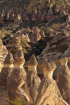 Cylindrical stone cliffs and cave houses near Goreme, Turkey