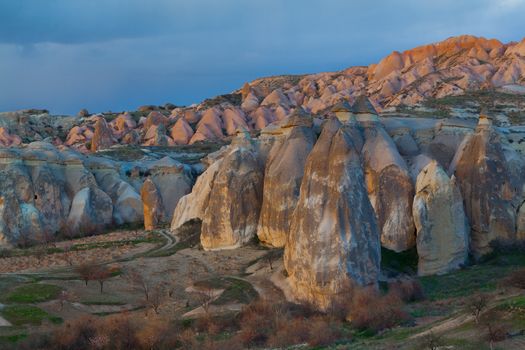 Cylindrical stone cliffs and cave houses near Goreme, Turkey