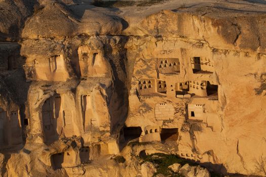 Cylindrical stone cliffs and cave houses near Goreme, Turkey