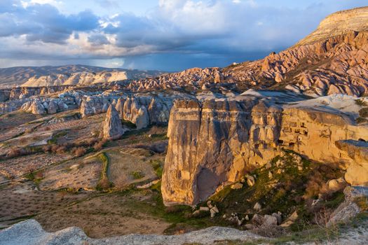 Cylindrical stone cliffs and cave houses near Goreme, Turkey