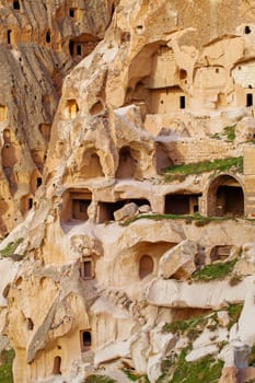 Stone cliffs and cave houses in Uchisar near Goreme, Turkey