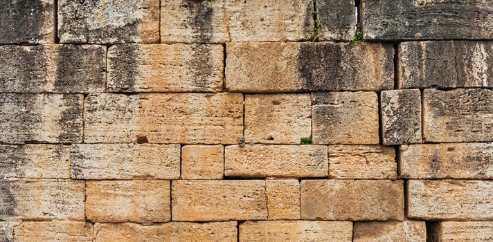 Texture of stone wall in ancient city Hierapolis, near Pamukkale, Turkey