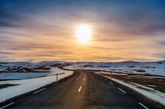 A long straight road at sunset in winter. 