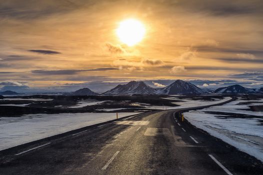 A long straight road at sunset in winter. 