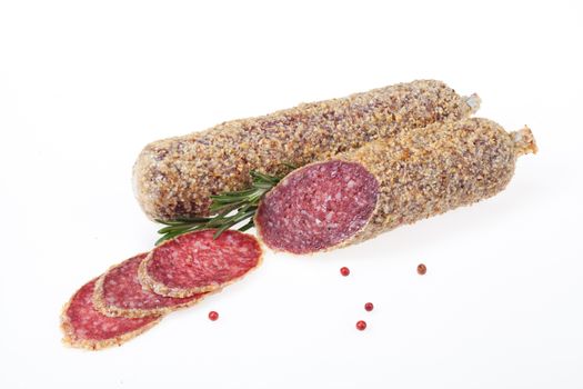 Isolated sausage with greenery on a white studio background