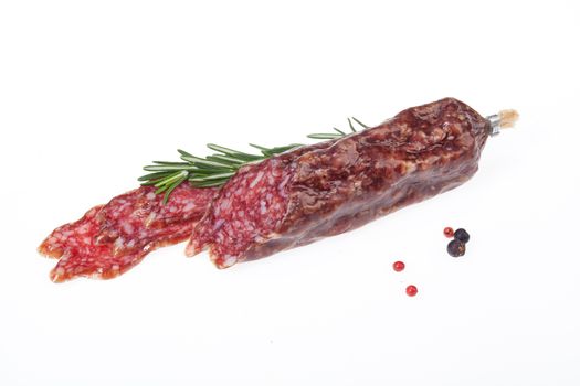 Isolated sausage with greenery on a white studio background
