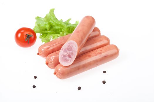Isolated sausage with greenery on a white studio background