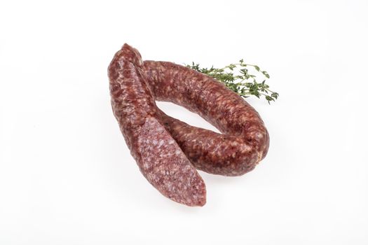 Sausge with greenery on an isolated studio background