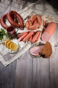 Sausages and vegetables on an old wooden desk