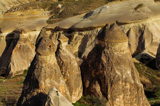 Cylindrical stone cliffs and cave houses near Goreme, Turkey