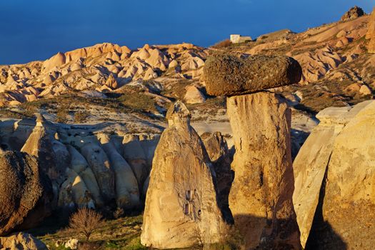 Cylindrical stone cliffs and cave houses near Goreme, Turkey