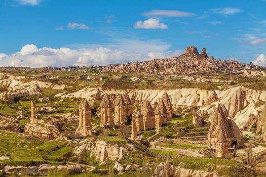 Cylindrical stone cliffs and cave houses near Goreme, Turkey