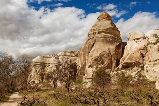 Cylindrical stone cliffs and cave houses near Goreme, Turkey