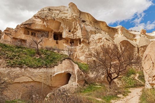 Cylindrical stone cliffs and cave houses near Goreme, Turkey