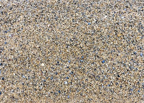 texture of the sand on the lake, come across small stones