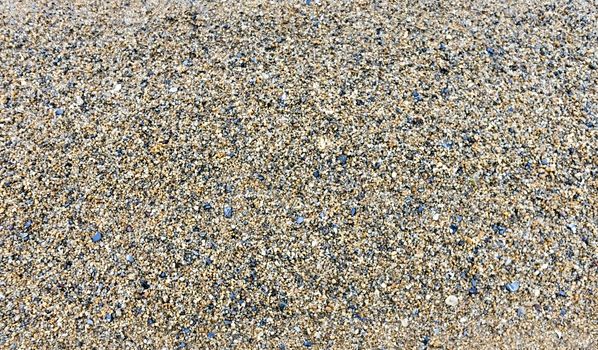 texture of the sand on the lake, come across small stones