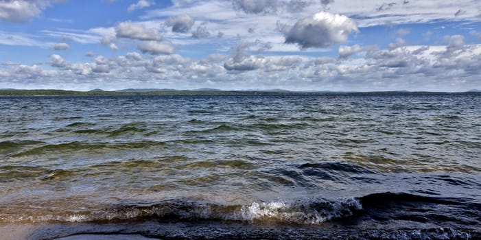 view of the blue sky over the lake with beautiful feathery and cumulonimbus clouds on a Sunny day, the southern Urals, lake Uvildy