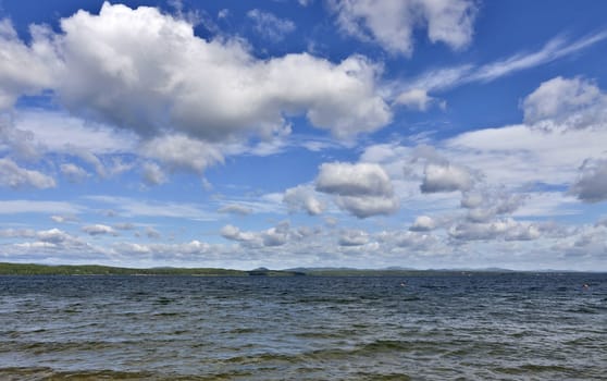 view of the blue sky over the lake with beautiful feathery and cumulonimbus clouds on a Sunny day, the southern Urals, lake Uvildy