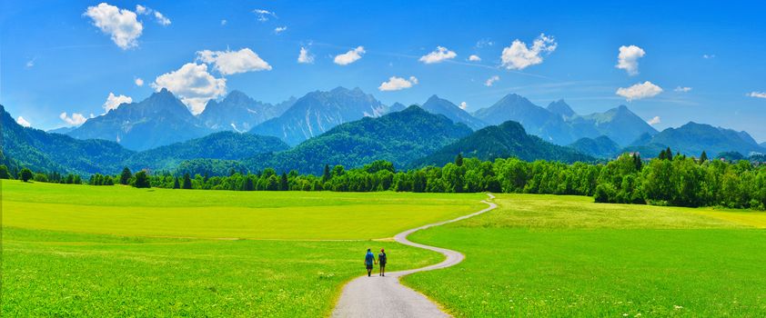 Couple going to summer mountains, Schwangau, Germany