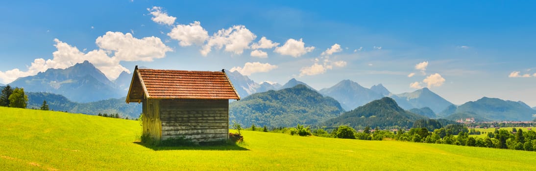 Old little house in summer mountains