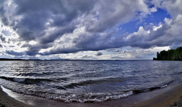 dark gray sky over the restless lake, the wind blows