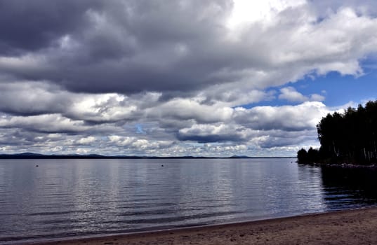 dark gray sky over a calm lake, the wind does not blow