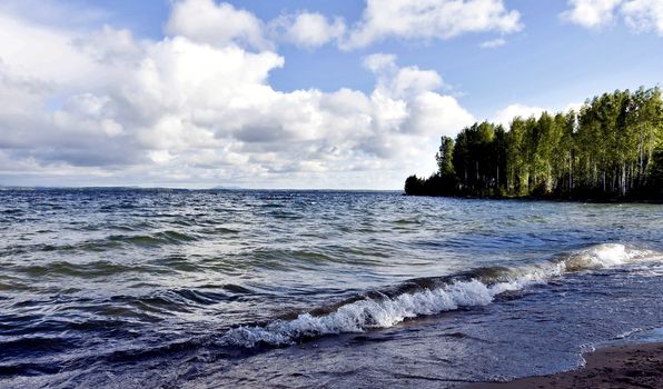 dark gray sky over the restless lake, the wind blows