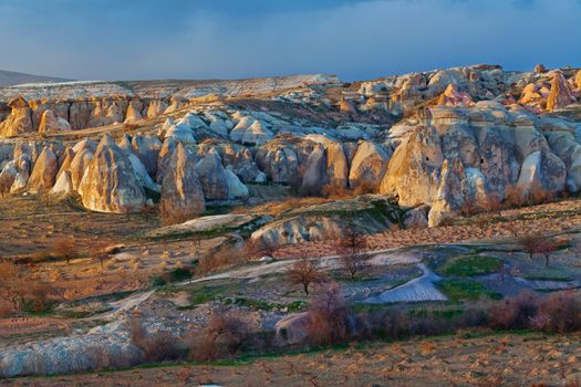 Cylindrical stone cliffs and cave houses near Goreme, Turkey