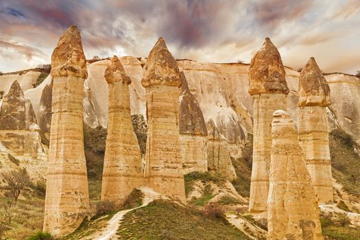 Cylindrical stone cliffs and cave houses in Love valley near Goreme, Turkey