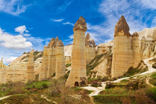 Cylindrical stone cliffs and cave houses in Love valley near Goreme, Turkey