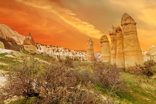 Cylindrical stone cliffs and cave houses in Love valley near Goreme, Turkey