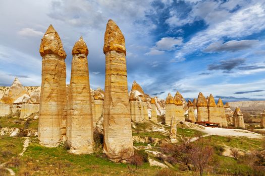 Cylindrical stone cliffs and cave houses in Love valley near Goreme, Turkey