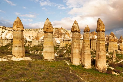 Cylindrical stone cliffs and cave houses in Love valley near Goreme, Turkey