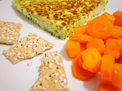Healthy eating serving omelette with vegetables, carrots and crackers