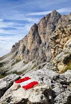 Trail mark on a stone in Dolomites, Italy